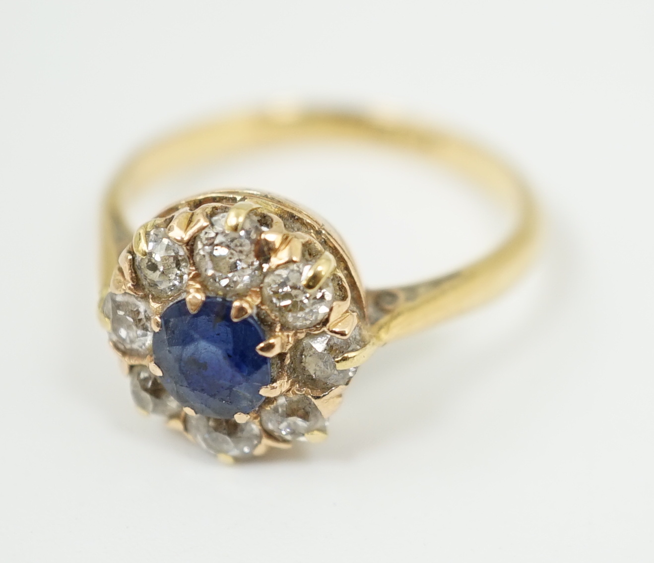 An 18ct gold, sapphire and diamond cluster ring